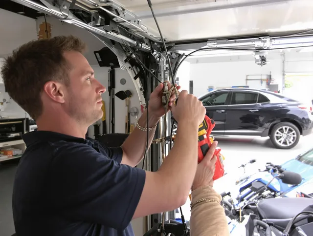 Columbus Garage Door Repair safety certified technician performing cable replacement in Columbus